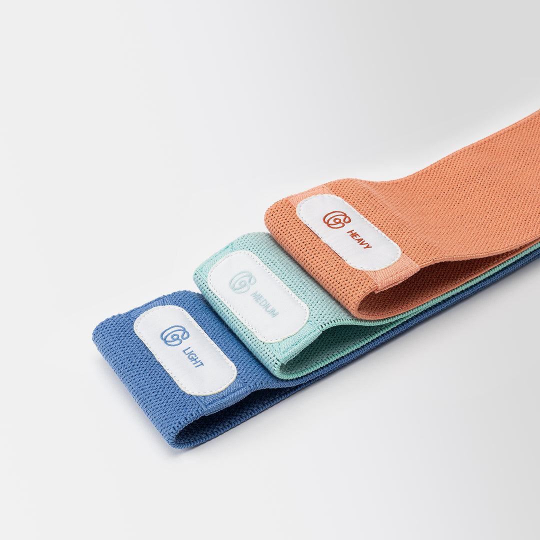 Booty Bänder in blau, türkis und orange mit Gymondo-Logo vor neutralem Hintergrund